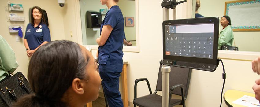 Student looking at monitor reading health information.